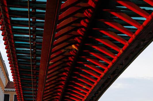 Geometric patterns and reflections in modern red bridge architecture photo