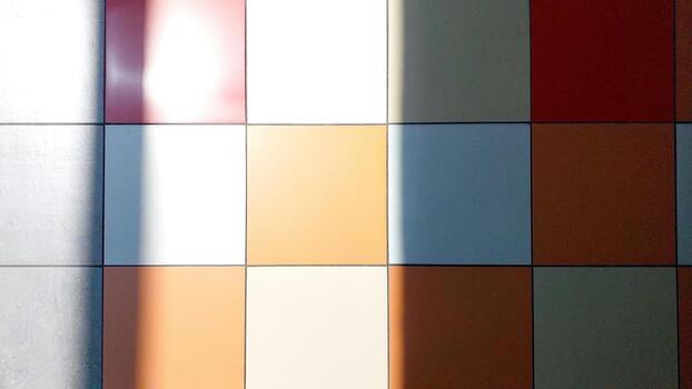 Colorful Tiled Floor With Shadows Creating Patterns in a Well-Lit Indoor Space During the Day photo