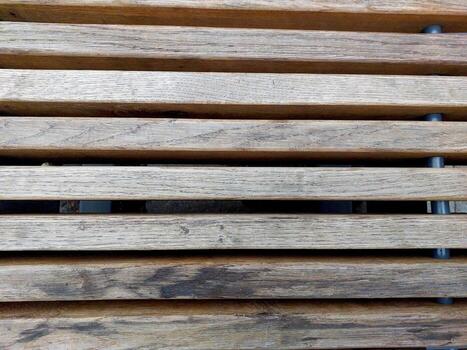 Wooden Strips Arranged on a Bench Surface in a Quiet Outdoor Setting During Daytime photo