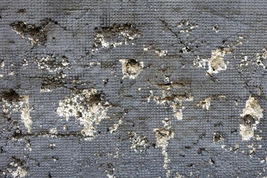 Thermal insulation on the wall with square gray texture and white foam notches photo