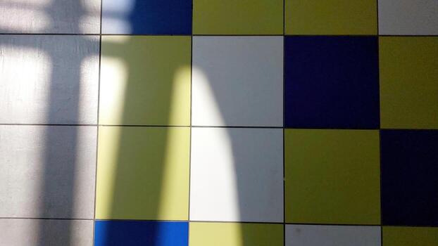 Colorful Tiled Floor With Shadow Patterns Creating Visual Contrast in a Well-Lit Space photo