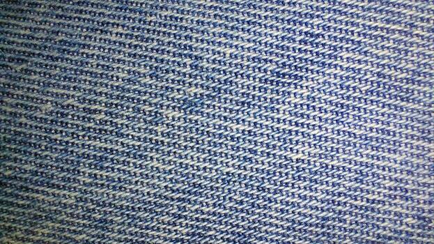 Denim fabric texture close up showcasing weave and color variations for fashion design photo