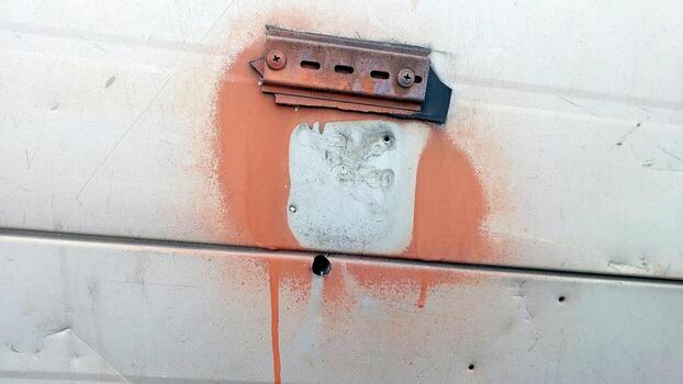 Old Wall Panel Mount With Rusty Metal and Paint Drips on a Weathered Surface photo