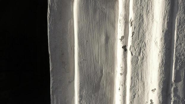White Lime Wall With Textured Edges Illuminated by Soft Light photo