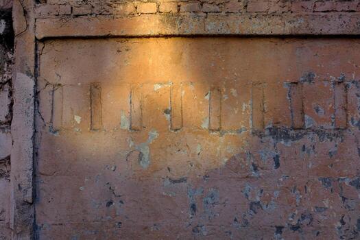 Red wall with ledges and bricks on top. Poor surface condition with peeling paint texture photo