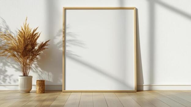 A blank frame in front of a window and a plant photo
