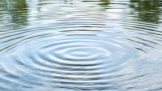 A circular ripple in a lake with trees in the background photo
