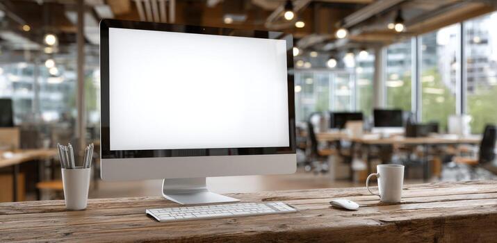 Modern desktop workspace featuring a sleek computer monitor with blank screen, minimalist design elements, wooden table, and bright office environment with natural light photo