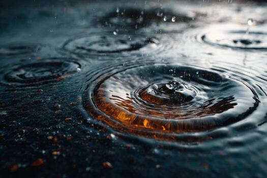 Close-up view of raindrops creating ripples on a dark surface, with reflections of light and water droplets enhancing the serene atmosphere of a rainy day photo