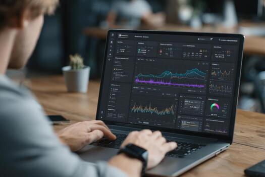 Young man analyzing data on laptop screen with colorful graphs and charts, surrounded by modern workspace elements, showcasing digital analytics and technology in action photo