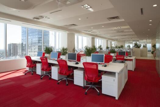 Modern office interior featuring bright red chairs and desks, large windows allowing natural light, plants enhancing the workspace, creating a vibrant and productive atmosphere photo