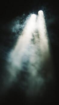 Dramatic light beams cutting through fog in a dimly lit space during an evening performance. photo
