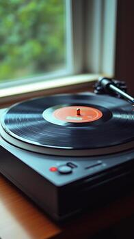 Vibrant turntable setup with record spinning in low light photo
