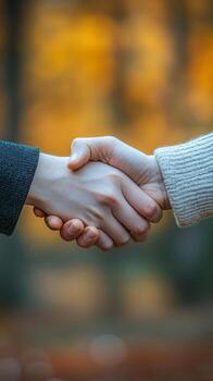 Hands Shaking in Agreement, Symbolizing Unity and Trust Between Two Individuals Outdoors photo