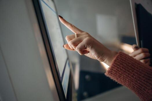 Person touching a touchscreen display photo