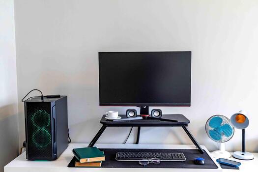 A comfortable, organized, clean, and minimalist work and study desk, with a computer, monitor, keyboard, mouse, and lamp. c photo