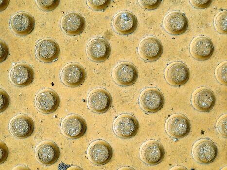 A textured yellow surface with intricate circular patterns creates an engaging backdrop photo