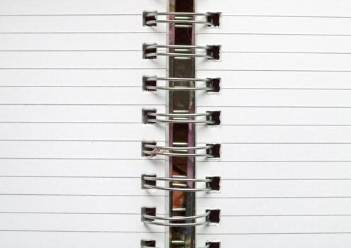 A CloseUp Image Showing the Binding of a Spiral Notebook, Capturing Its Intricate Details. photo