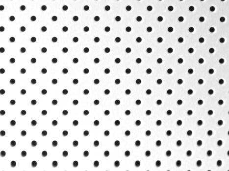 A beautifully Textured Perforated Surface featuring an array of Circular Holes for design photo