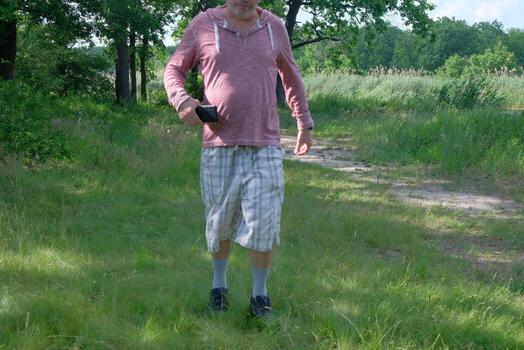 A man in the forest pours coffee while relaxing and doing sports by running in the forest photo