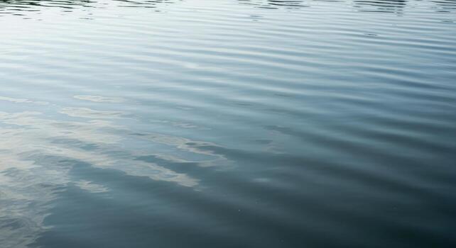 Serene Water Surface Reflecting Sky with Gentle Ripples photo