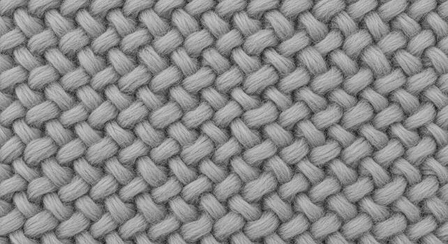 Close-up of a soft, gray knitted fabric showcasing a detailed, intricate weave pattern, perfect for cozy and comforting textile backgrounds and designs photo
