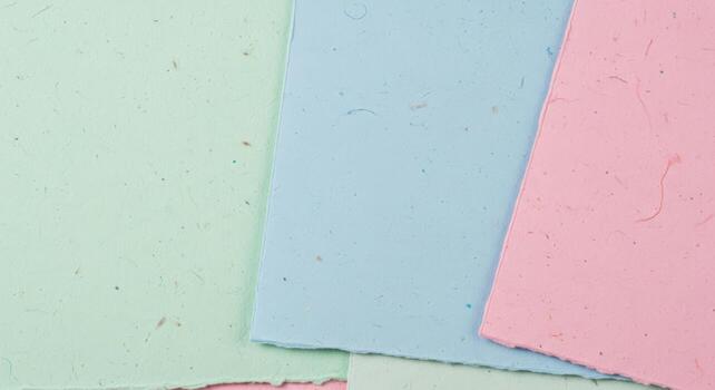 Textured Layers of Handcrafted Pastel Papers A Serene Backdrop Featuring Soft Green, Blue, and Pink Sheets photo