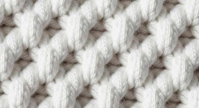 Close-up macro shot of a thick white knitted textile pattern, showcasing intricate cable knit stitches and soft wool fibers photo