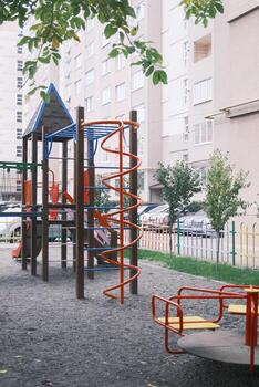 A playground with a swing set and a slide photo
