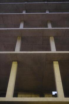 A concrete building with a light shining through the windows photo