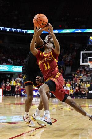 Iowa State Cyclones guard Dominick Nelson (11) is founded by Grambling State Tigers forward Richard Amaefule (10) during the first half at James H. Hilton Coliseum. editorial_image