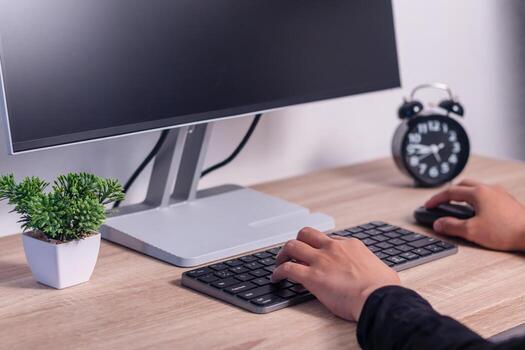 Close up of a woman working or studying on computer. Female hands on computer keyboard and mouse. photo