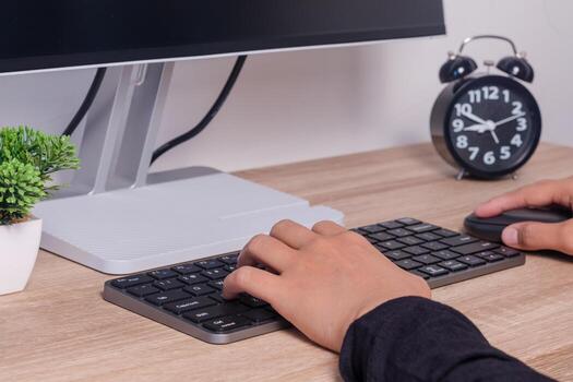 Female hands on computer keyboard and mouse. Working or studying on computer. photo