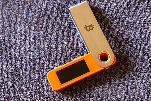 Hardware security device rests flat on textured surface in indoor setting. photo