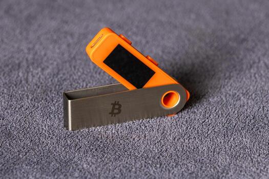 hardware Bitcoin wallet displayed on a table in indoor setting. Secure device highlights technological advancements for digital currency storage. photo