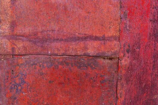Worn red painted surface with seams, scratches and discoloration, showing signs of age and use - Full-frame background and texture. photo