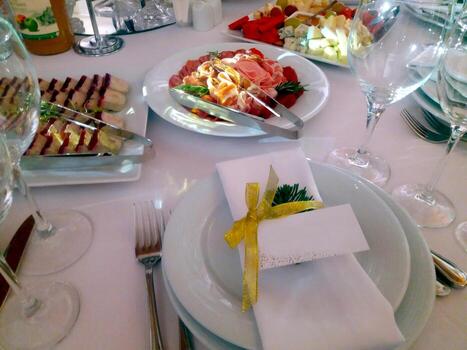 Festive Dining Table Layout Featuring Delicious Food and Guest Card for Special Occasion photo