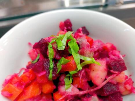 Colorful Salad With Leek, Potato, and Beet Served in a Bowl on a Countertop photo