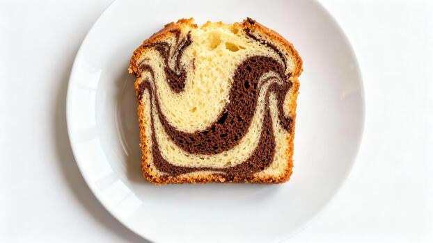 Single slice of marbled vanilla and chocolate pound cake rests on a white plate overhead photo