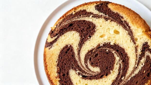 Slice of homemade swirl cake displays intricate patterns of vanilla and chocolate batter photo