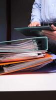 A man is holding a tablet computer and a stack of folders video