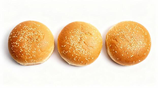 Three golden baked bread rolls topped with sesame seeds are lined up against a white background. photo