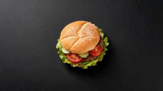 Single prepared sandwich sits centered on a dark, plain background viewed from above photo
