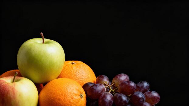 Assortment of fresh fruits piled together against a solid dark background photo
