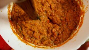 Vegetable paste showing depth of color and smooth finish with blender. Light reflects off surface and show appetizing food. Concept of vegetable spread as culmination of blending ritual. video