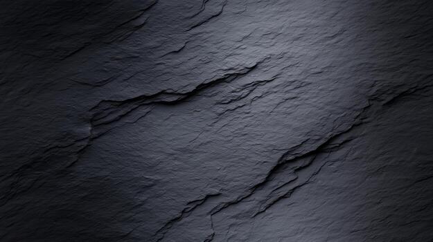 A detailed close-up view of dark gray slate, exhibiting intricate patterns of cracks and layers. photo