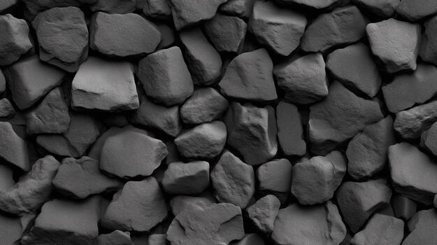 A close-up view of a textured wall composed of various dark gray stones, showcasing a rich, natural stone pattern. photo