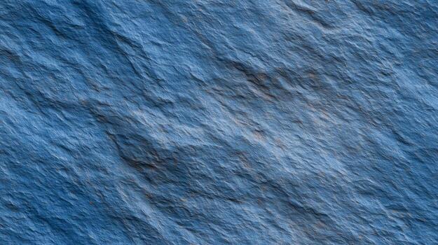 A detailed close-up view of textured blue rock, showcasing its intricate patterns and variations in shade. photo