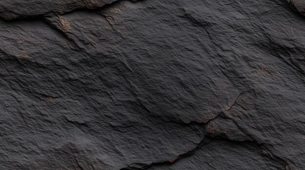 A close-up view of dark, textured rock, showcasing deep crevices and uneven surfaces. photo