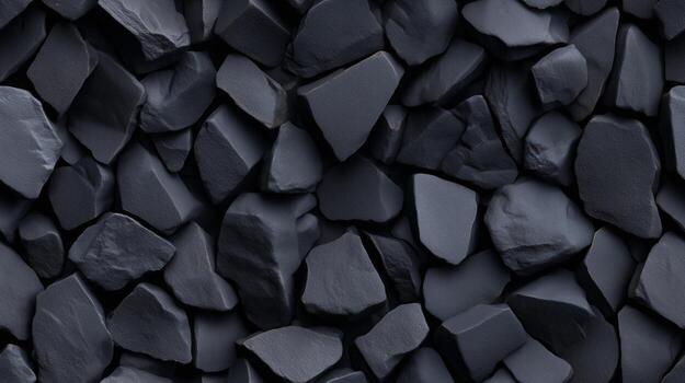 A close-up view of a textured surface composed of many dark gray, jagged rocks, creating a visually interesting and solid pattern. photo